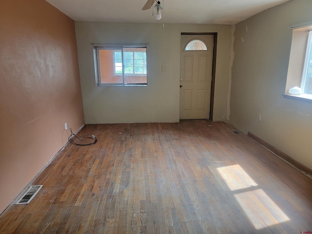 foyer entrance with ceiling fan and hardwood / wood-style floors