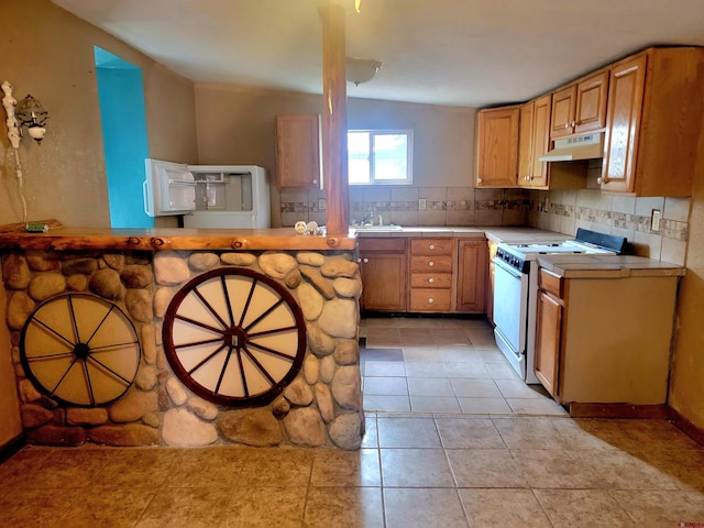 kitchen featuring white range, decorative backsplash, vaulted ceiling, and light tile patterned floors