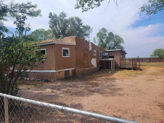 view of side of property featuring a wooden deck