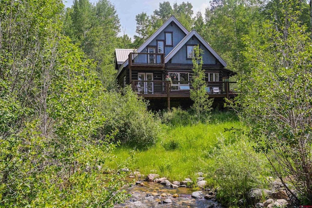 back of property featuring a deck