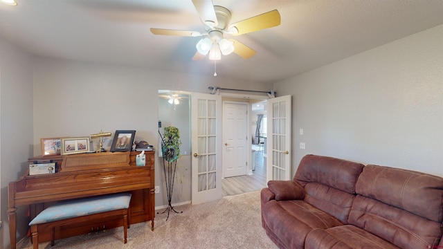 living room with carpet, french doors, and ceiling fan