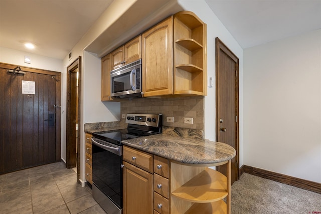 kitchen with tasteful backsplash, dark stone counters, a kitchen breakfast bar, dark carpet, and stainless steel appliances