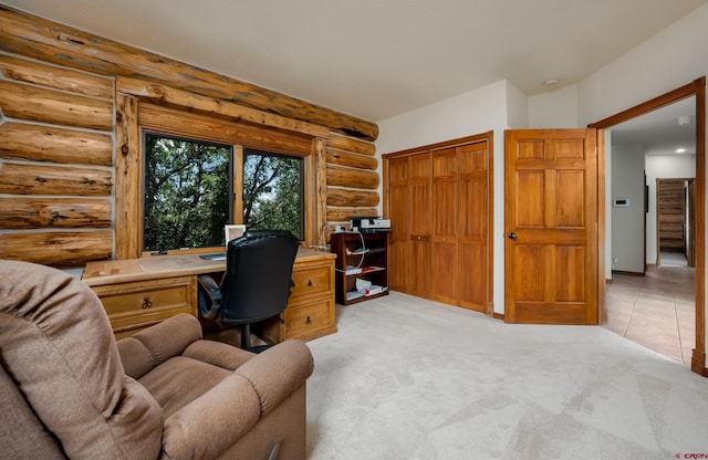 office space with light colored carpet and log walls