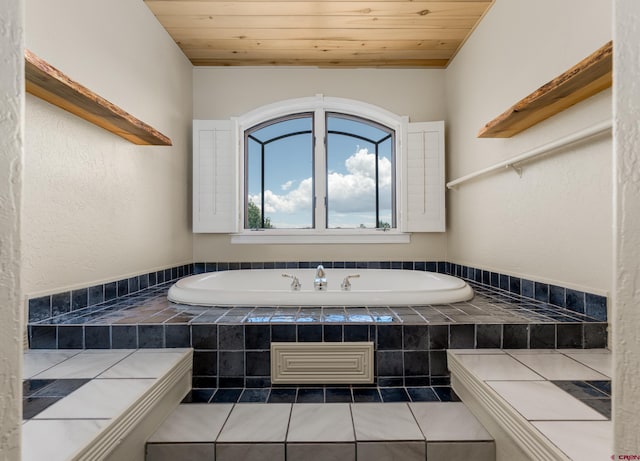 bathroom featuring tiled bath, tile patterned floors, and wood ceiling