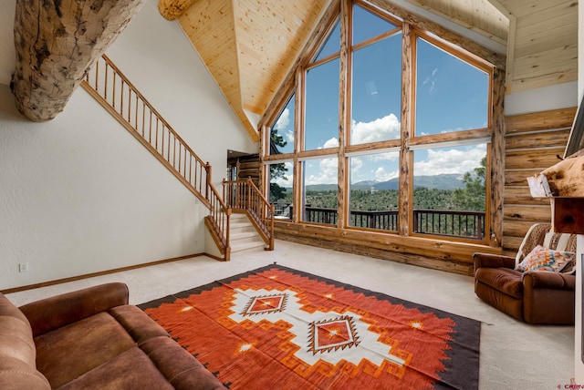 carpeted living room featuring a mountain view, log walls, high vaulted ceiling, and wooden ceiling