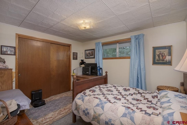 bedroom featuring a closet and carpet flooring