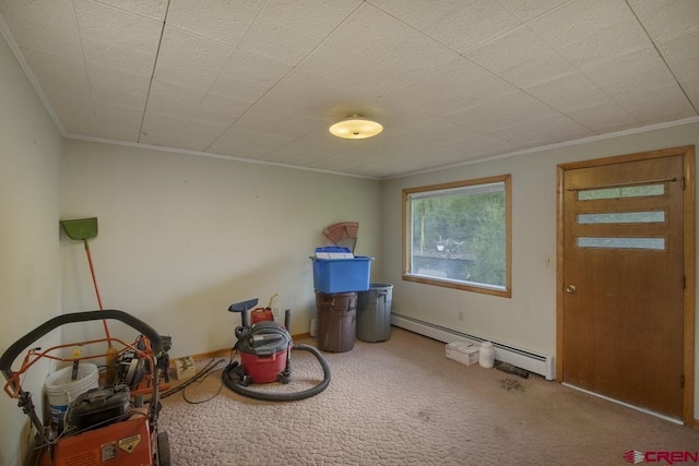 miscellaneous room featuring a baseboard heating unit, ornamental molding, and carpet floors