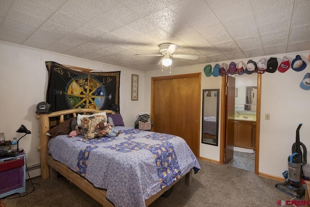 bedroom featuring a baseboard radiator, carpet flooring, sink, ceiling fan, and ensuite bath