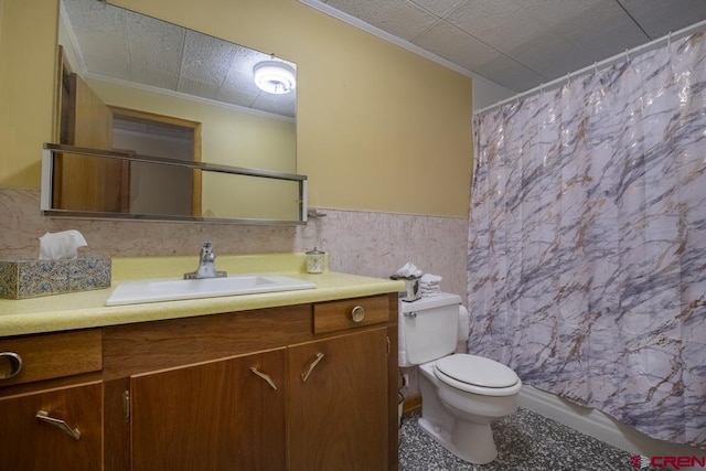 bathroom with ornamental molding, toilet, vanity, and tile walls