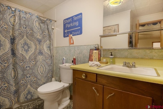 bathroom featuring vanity, a textured ceiling, and toilet