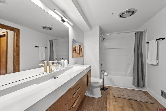 full bathroom with wood-type flooring, toilet, vanity, and shower / bath combo with shower curtain