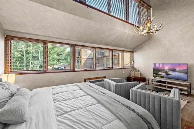 bedroom with hardwood / wood-style floors and a chandelier