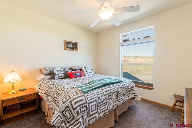 bedroom featuring ceiling fan and dark carpet