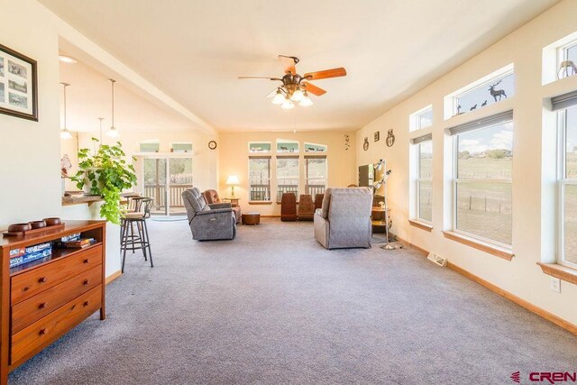 sunroom / solarium featuring ceiling fan and a wealth of natural light