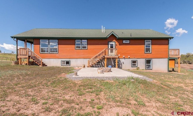 back of property featuring a patio and a yard