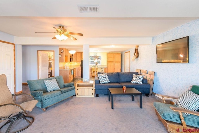 living room featuring light colored carpet and ceiling fan