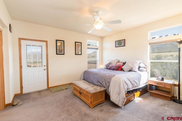 bedroom with multiple windows, light carpet, and ceiling fan