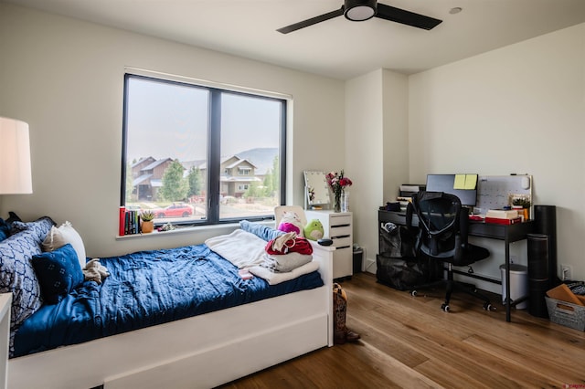 bedroom featuring wood finished floors and a ceiling fan