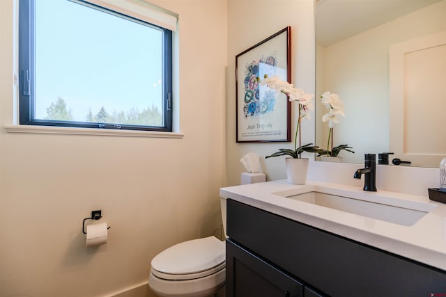 half bath featuring toilet and vanity