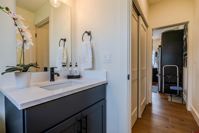 bathroom with vanity and wood finished floors