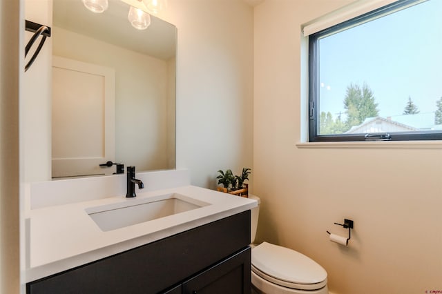 bathroom featuring toilet and vanity