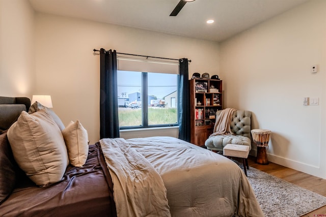 bedroom with ceiling fan and light hardwood / wood-style floors