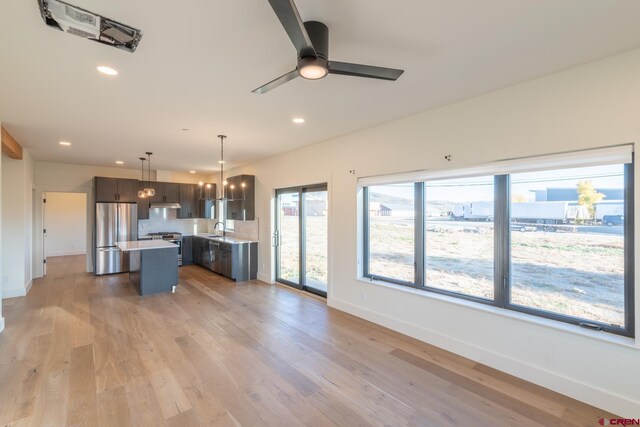 living room featuring hardwood / wood-style flooring and ceiling fan with notable chandelier