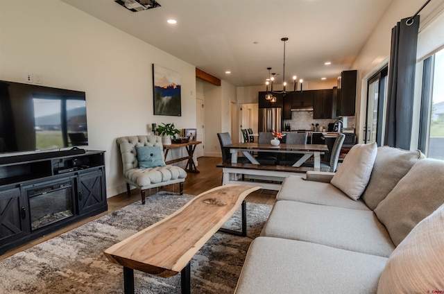 living room featuring hardwood / wood-style flooring and a chandelier