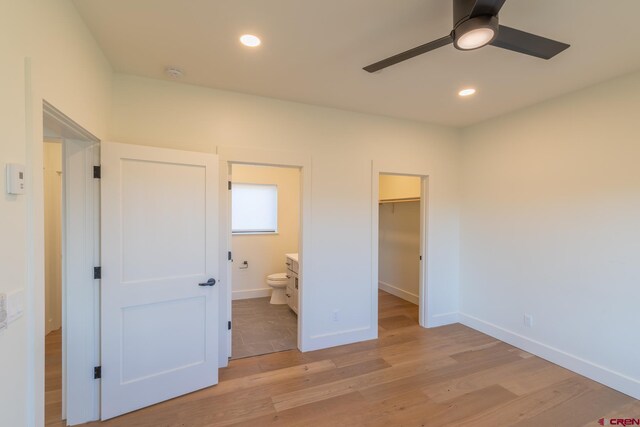 kitchen with a notable chandelier, a center island, stainless steel dishwasher, light hardwood / wood-style floors, and pendant lighting