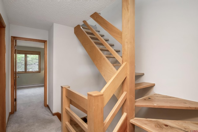 11 Morning Glory Way Unit 6, Crested Butte, CO 81225 - staircase featuring a baseboard radiator, carpet floors, a textured ceiling, and baseboards