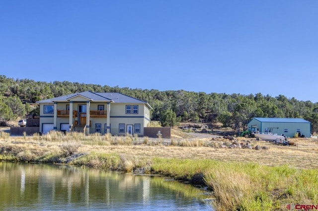 rear view of property featuring a water view