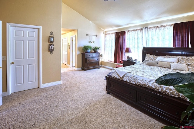 carpeted bedroom featuring high vaulted ceiling