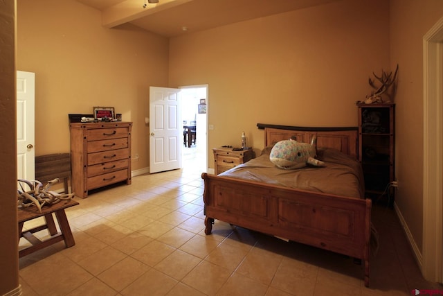 bedroom featuring beamed ceiling and light tile patterned floors