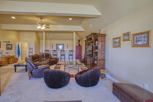 carpeted living room featuring lofted ceiling with beams and ceiling fan