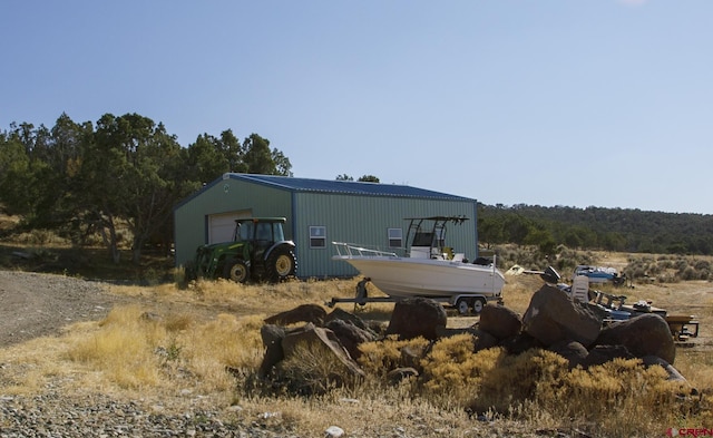 exterior space featuring a garage and an outdoor structure