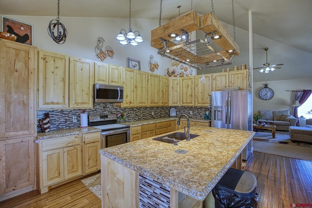 kitchen with an island with sink, appliances with stainless steel finishes, sink, and light brown cabinets