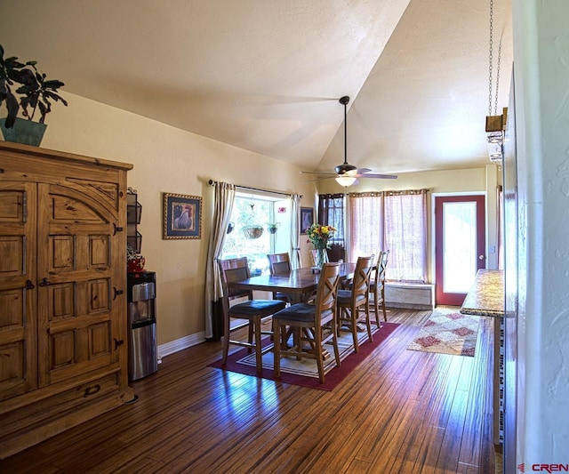 dining area featuring ceiling fan, dark hardwood / wood-style flooring, and vaulted ceiling