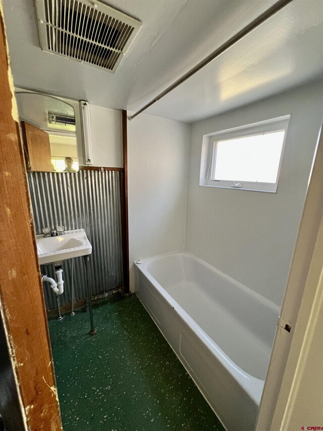 bathroom with sink and a bathtub