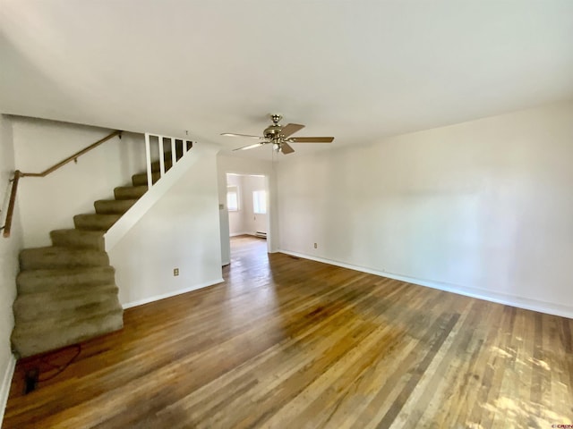 unfurnished living room featuring hardwood / wood-style floors, a baseboard radiator, and ceiling fan