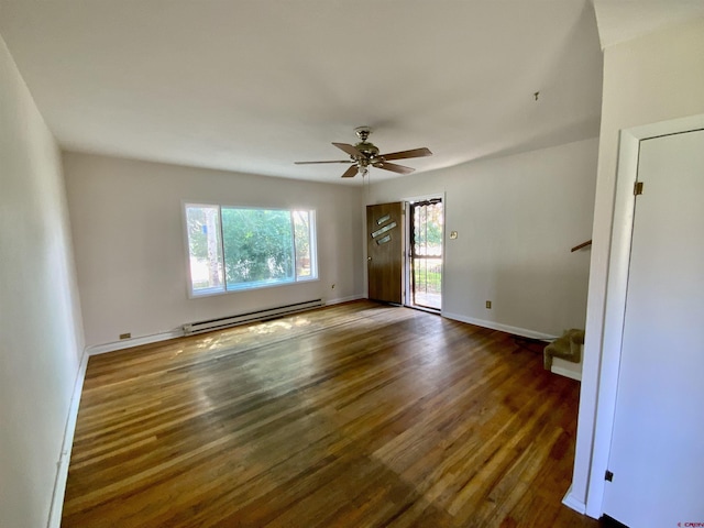 spare room with dark hardwood / wood-style flooring, a baseboard radiator, and ceiling fan