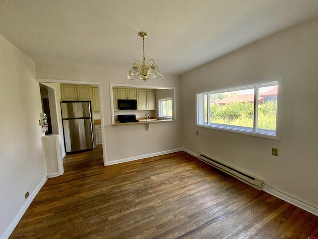 interior space with an inviting chandelier, dark wood-type flooring, a baseboard radiator, and a wealth of natural light