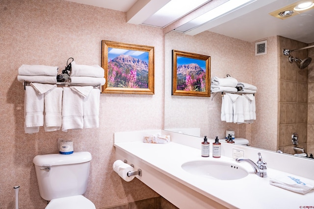 bathroom featuring toilet and vanity