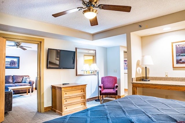 carpeted bedroom with a textured ceiling and ceiling fan