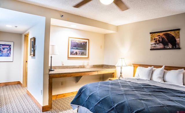 carpeted bedroom with a textured ceiling and ceiling fan