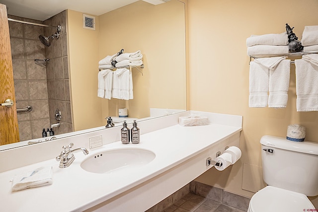 bathroom with tile patterned flooring, toilet, and vanity