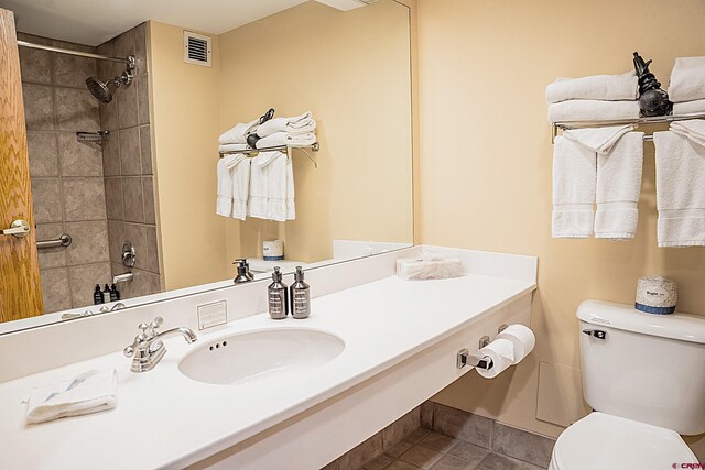 full bathroom with vanity, visible vents, tile patterned flooring, a shower, and toilet