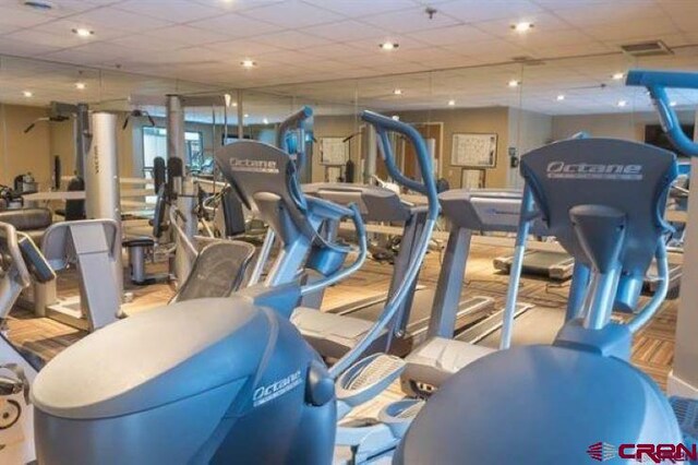 gym featuring a drop ceiling