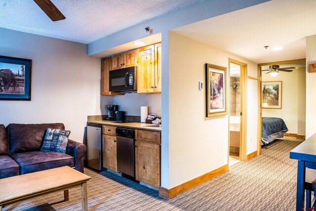 kitchen featuring ceiling fan, black microwave, light colored carpet, dishwasher, and stainless steel dishwasher