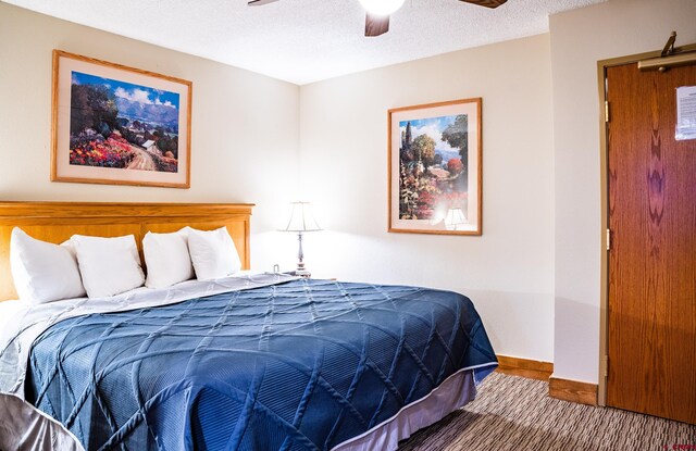 bedroom featuring a ceiling fan, baseboards, and a textured ceiling