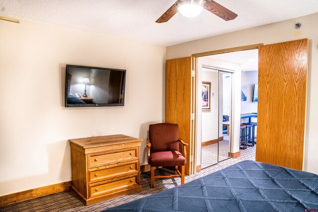 bedroom with visible vents, a textured ceiling, baseboards, and a ceiling fan